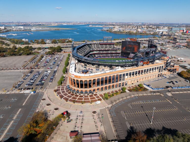 Aerial view of a city field stadium in New York with surrounding urban landscape