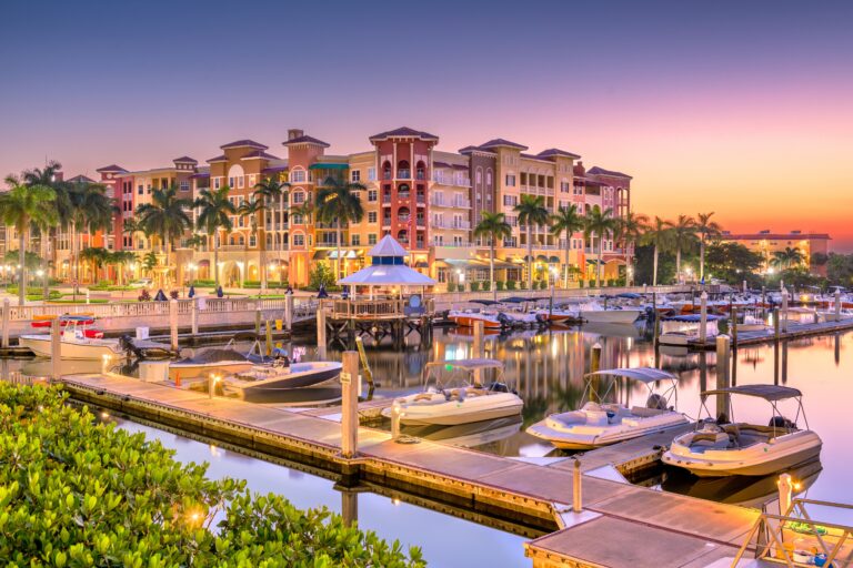 Naples, Florida, USA town skyline on the water at dawn.