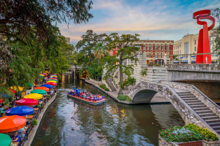 River walk in San Antonio city downtown skyline cityscape of Texas USA at sunset