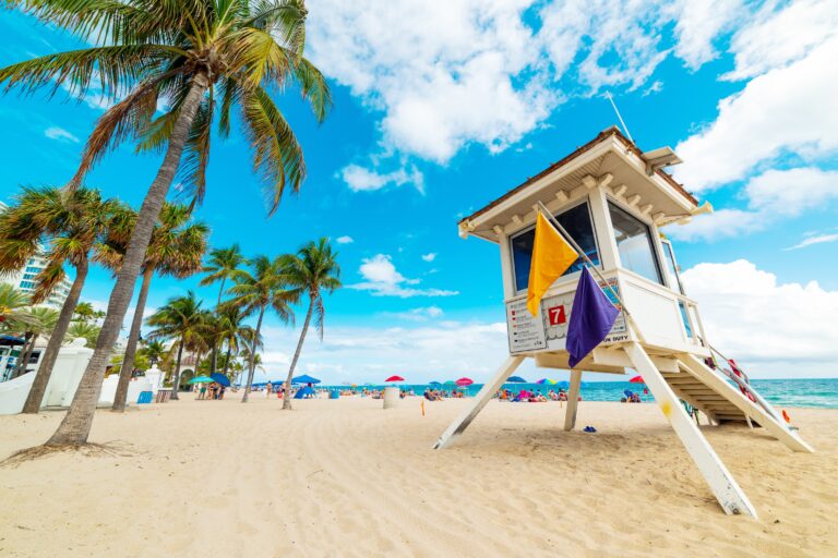 Lifeguard tower and palm trees in Fort Lauderdale shore. Florida, USA